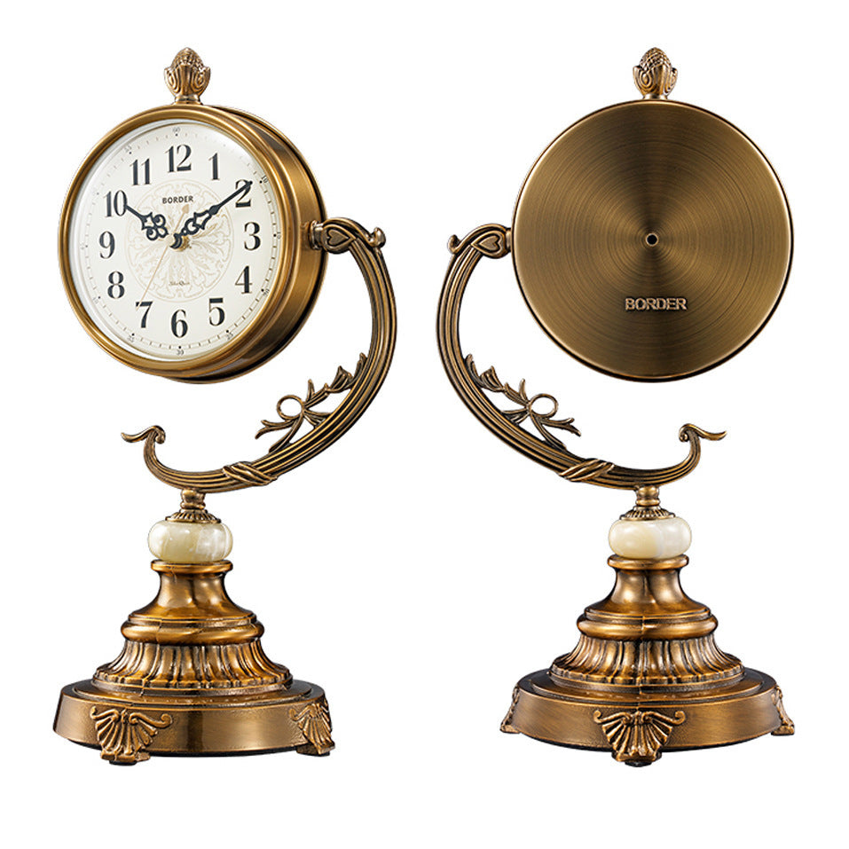 Bronze table clock with decorative design on a white background